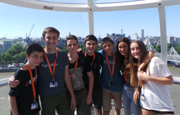 Teenagers on a city observation wheel during a summer language learning trip