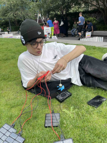 A boy on Academic Summer Camps Engineering course outdoors doing engineer project in a London Park
