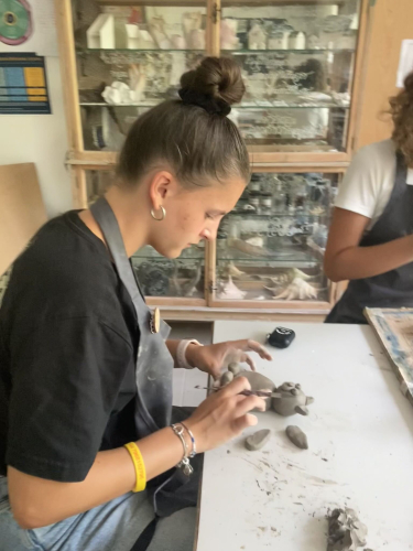 Art at Academic Summer. A girl making something with clay